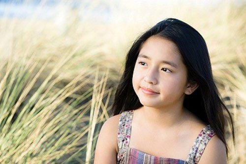 Why do children with precocious puberty need to be examined and treated?