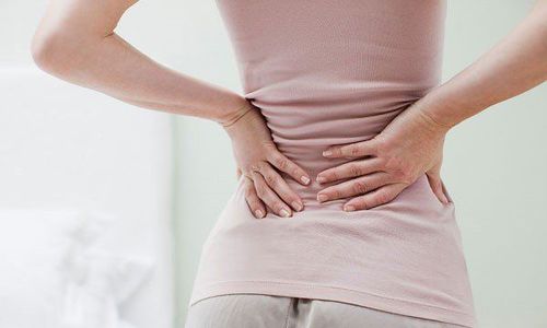 Low back pain is a symptom of what disease?