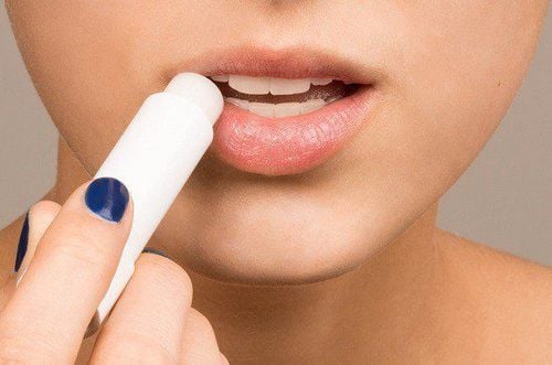 How should you apply lip balm to treat chapped lips?